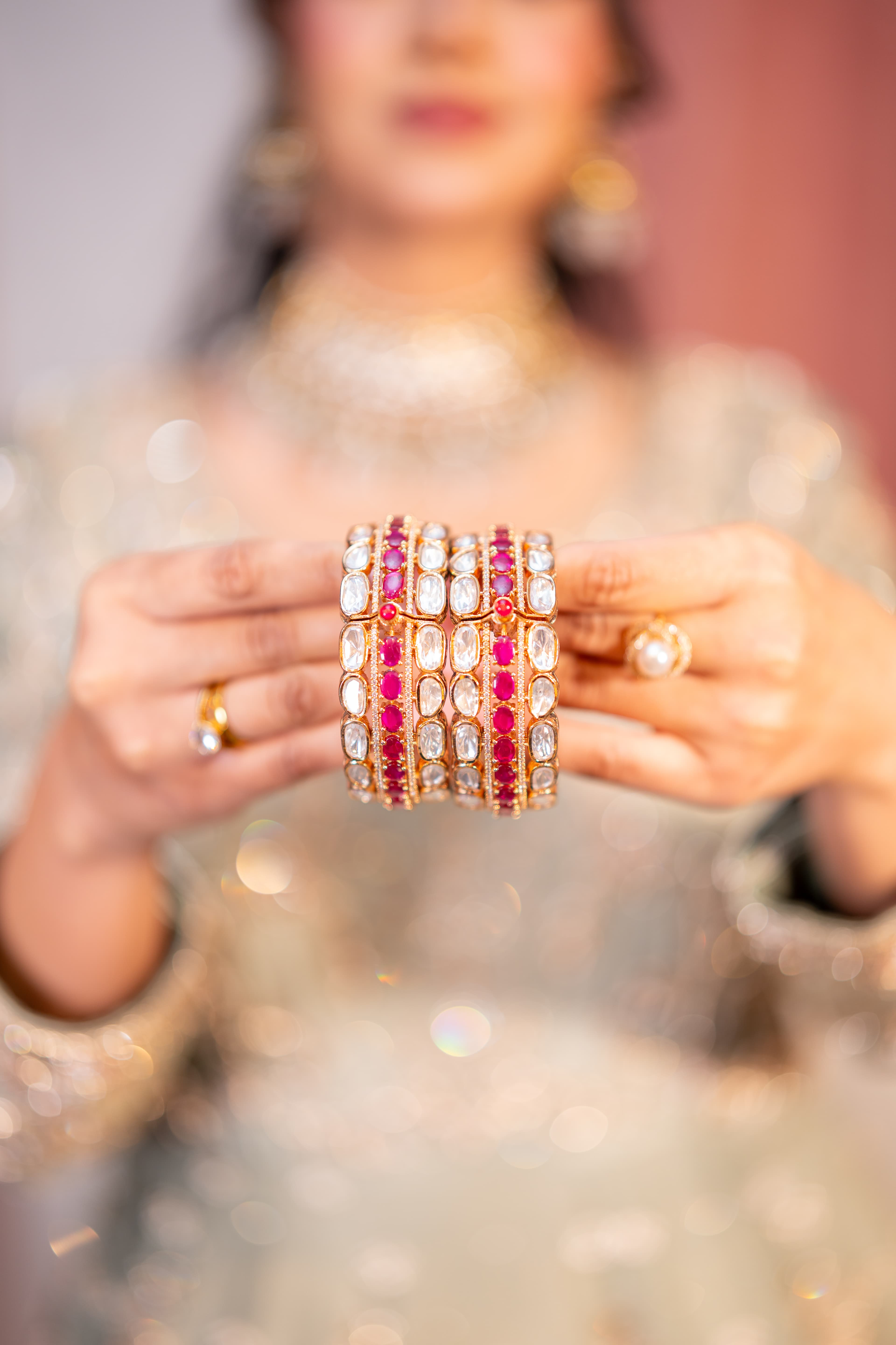 Decorative bridal bangles held between both hands.